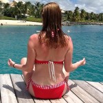Woman meditating in front of a beach