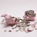 Broken piggy bank with coins spilling out